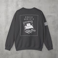 Dark Heather Chalk Addicts Crewneck by The No Rep Society, flat lay on grey concrete, back print of an open bag of gym chalk spilling across a bordered frame under CHALK ADDICTS lettering.