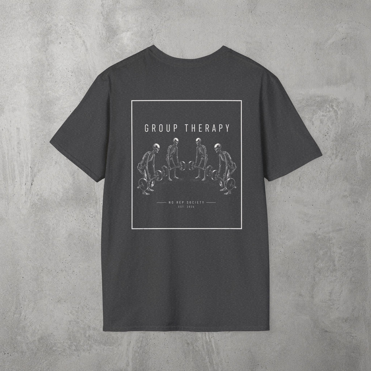 Dark Heather Group Therapy Tee by The No Rep Society, flat lay on grey concrete, back print of a circle of exhausted figures collapsed on the floor under GROUP THERAPY lettering.