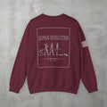 Maroon Human Devolution (WOMEN) Crewneck by The No Rep Society, flat lay on grey concrete, back print of evolution silhouettes ending face-down on the floor under HUMAN DEVOLUTION lettering.