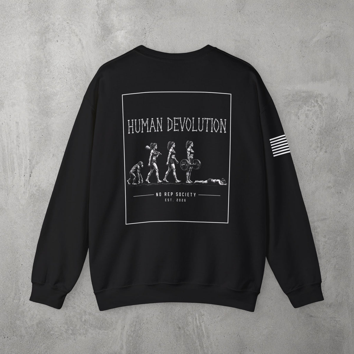 Black Human Devolution (WOMEN) Crewneck by The No Rep Society, flat lay on grey concrete, back print of evolution silhouettes ending face-down on the floor under HUMAN DEVOLUTION lettering.
