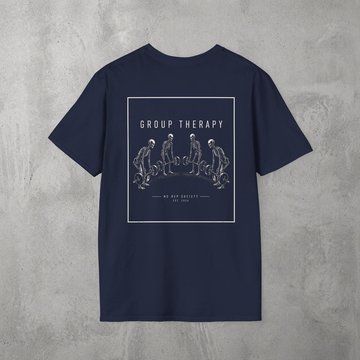 Navy Group Therapy Tee by The No Rep Society, flat lay on grey concrete, back print of a circle of exhausted figures collapsed on the floor under GROUP THERAPY lettering.