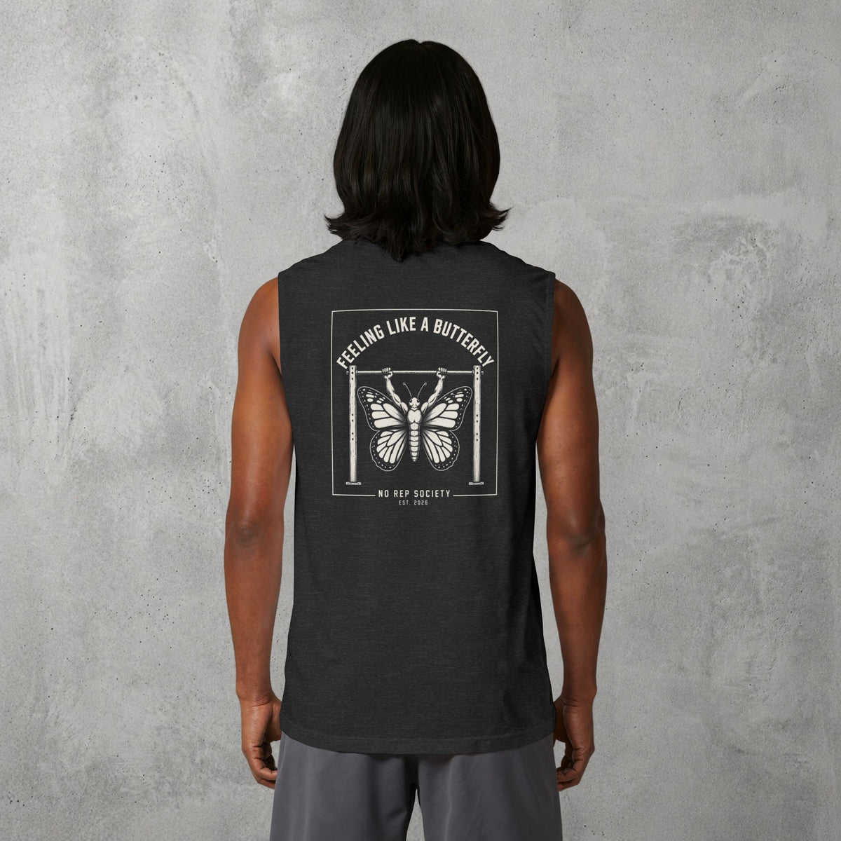 Dark Grey Heather Feeling Like A Butterfly Muscle Tank worn by a female model, back view showing the Feeling Like A Butterfly print.