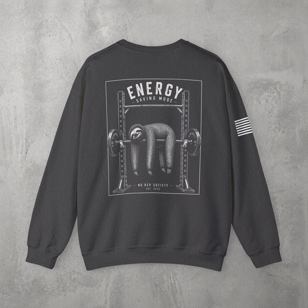 Dark Heather Energy Saving Mode Crewneck by The No Rep Society, flat lay on grey concrete, back print of a sloth hanging from a loaded barbell in a squat rack under ENERGY SAVING MODE lettering.