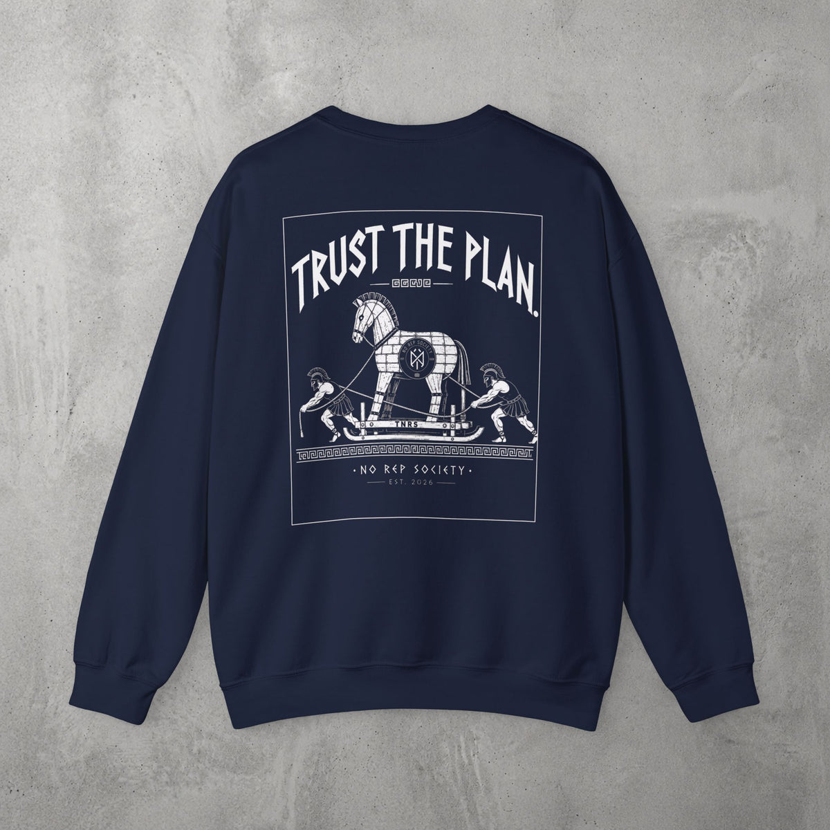 Navy Trust The Plan Crewneck by The No Rep Society, flat lay on grey concrete, back print of the Trojan Horse with figures around it under TRUST THE PLAN lettering.