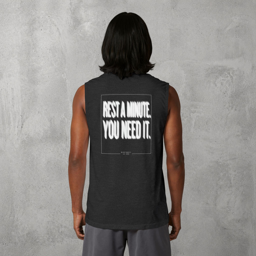 Dark Grey Heather Rest A Minute Muscle Tank worn by a female model, back view showing the Rest A Minute print.