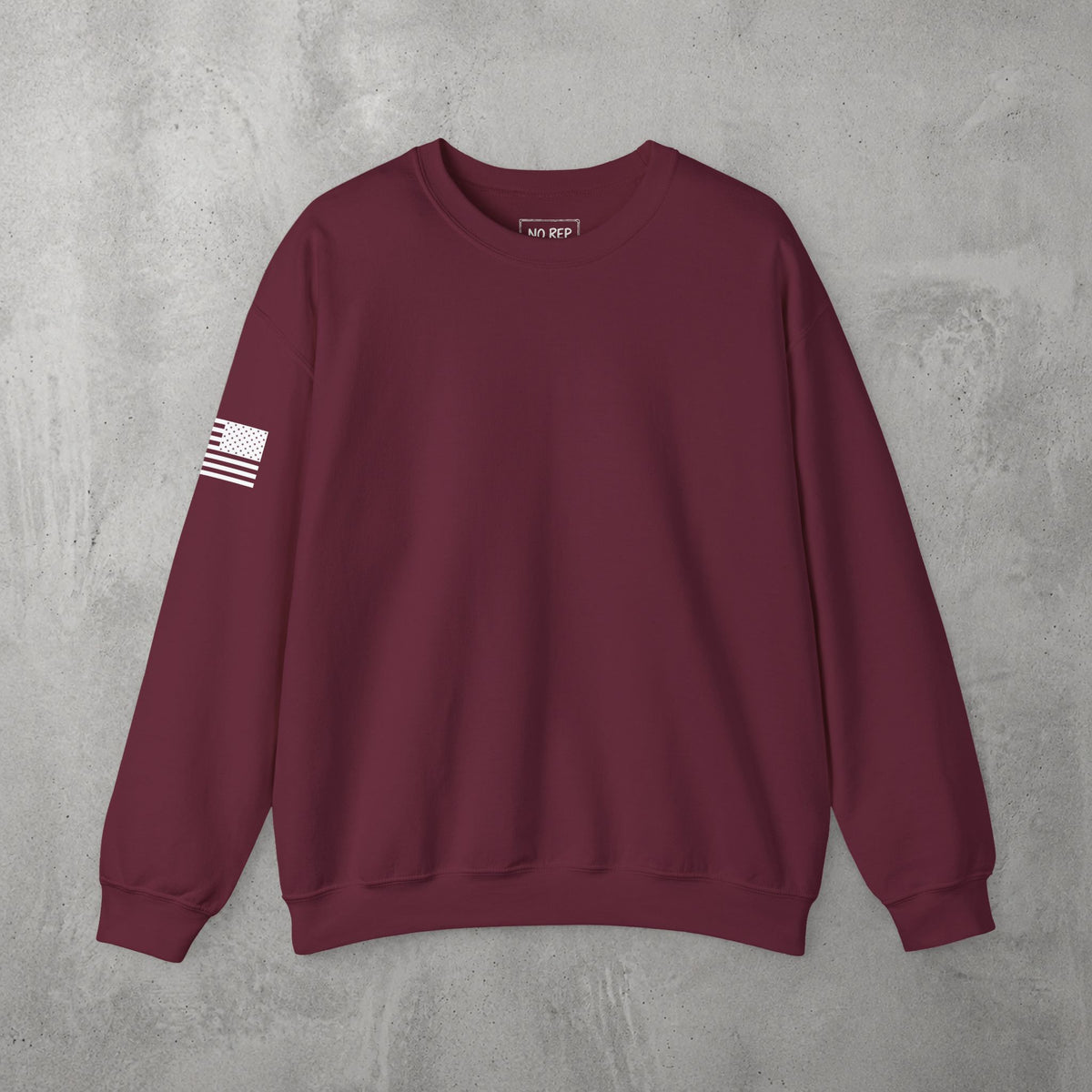 Maroon Chalk Addicts Crewneck by The No Rep Society, plain front view with no print, flat lay on grey concrete.