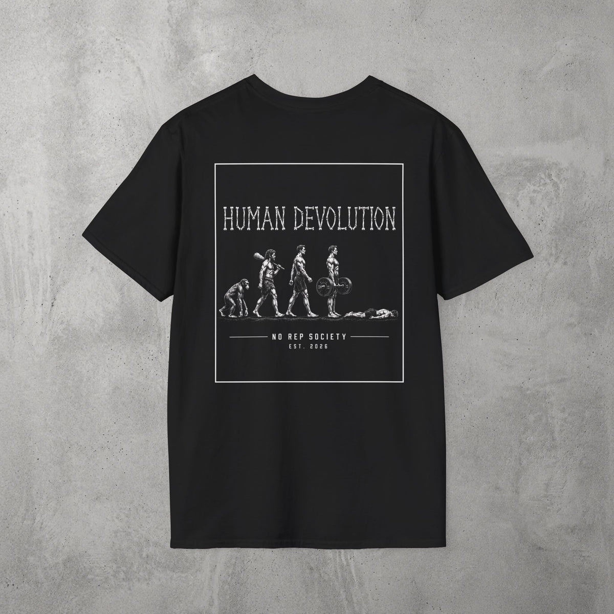 Black Human Devolution (MEN) Tee by The No Rep Society, flat lay on grey concrete, back print of evolution-of-man silhouettes ending face-down on the floor under HUMAN DEVOLUTION lettering.