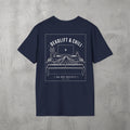 Navy Deadlift & Chill Tee by The No Rep Society, flat lay on grey concrete, back print of a bed and television drawn in fine line art under DEADLIFT & CHILL lettering.