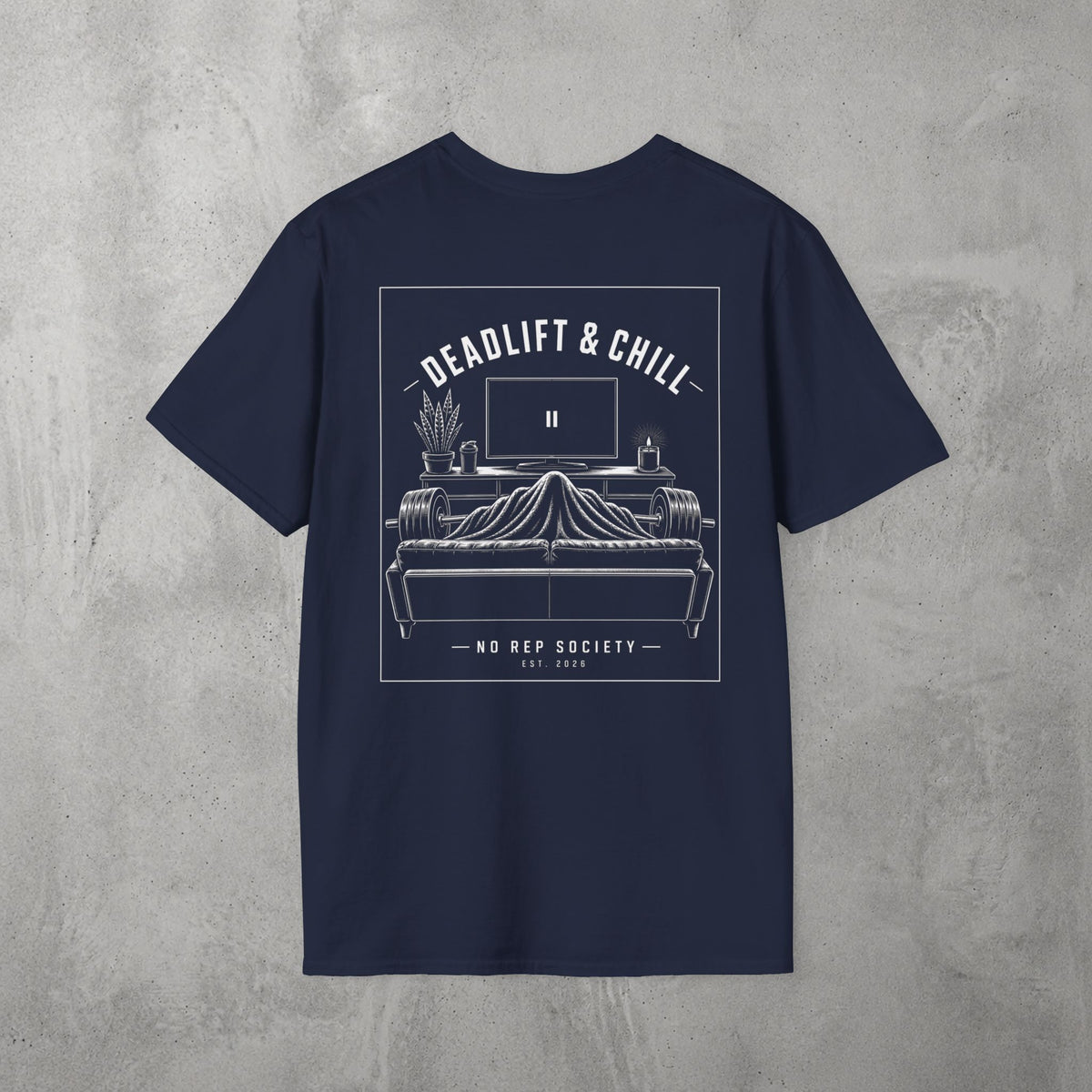 Navy Deadlift & Chill Tee by The No Rep Society, flat lay on grey concrete, back print of a bed and television drawn in fine line art under DEADLIFT & CHILL lettering.