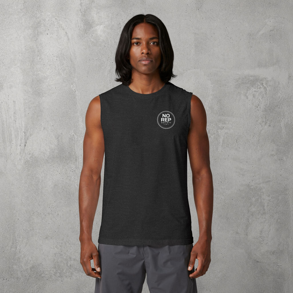 Model wearing the Dark Grey Heather NRS Clean Muscle Tank by The No Rep Society, minimal circular NO REP SOCIETY chest logo and no back print.