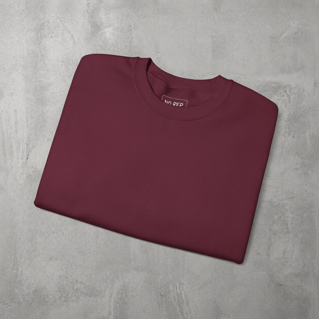 Maroon AMNRAP Crewneck by The No Rep Society, folded flat on grey concrete.