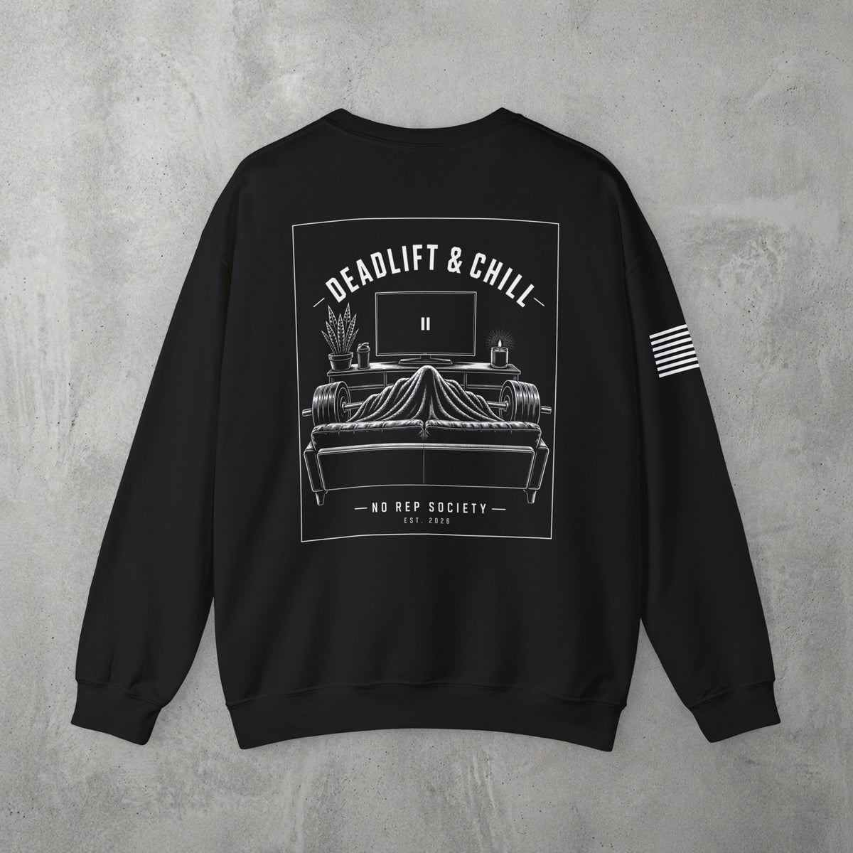 Black Deadlift & Chill Crewneck by The No Rep Society, flat lay on grey concrete, back print of a bed and television drawn in fine line art under DEADLIFT & CHILL lettering.