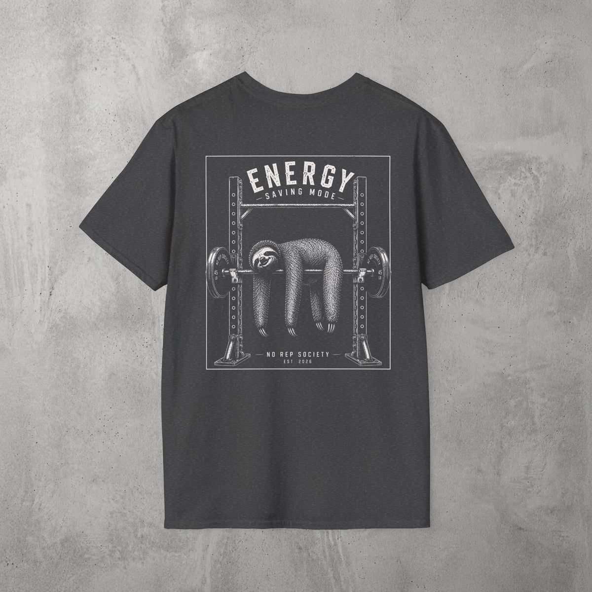 Dark Heather Energy Saving Mode Tee by The No Rep Society, flat lay on grey concrete, back print of a sloth hanging from a loaded barbell in a squat rack under ENERGY SAVING MODE lettering.