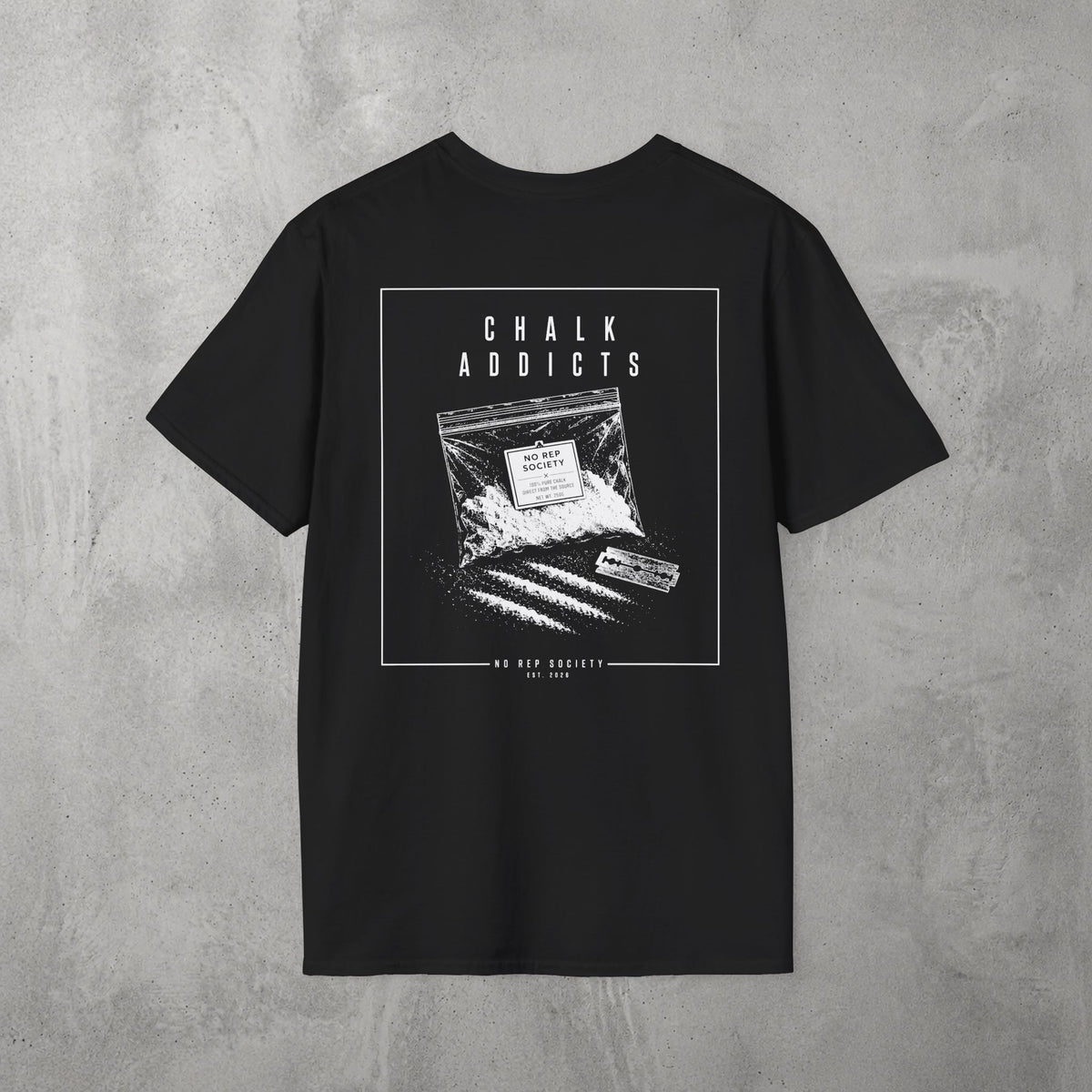 Black Chalk Addicts Tee by The No Rep Society, flat lay on grey concrete, back print of an open bag of gym chalk spilling across a bordered frame under CHALK ADDICTS lettering.