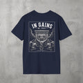 Navy In Gains We Trust Tee by The No Rep Society, flat lay on grey concrete, back print of an ornate temple facade with two kneeling figures and laurel branches under IN GAINS WE TRUST lettering.