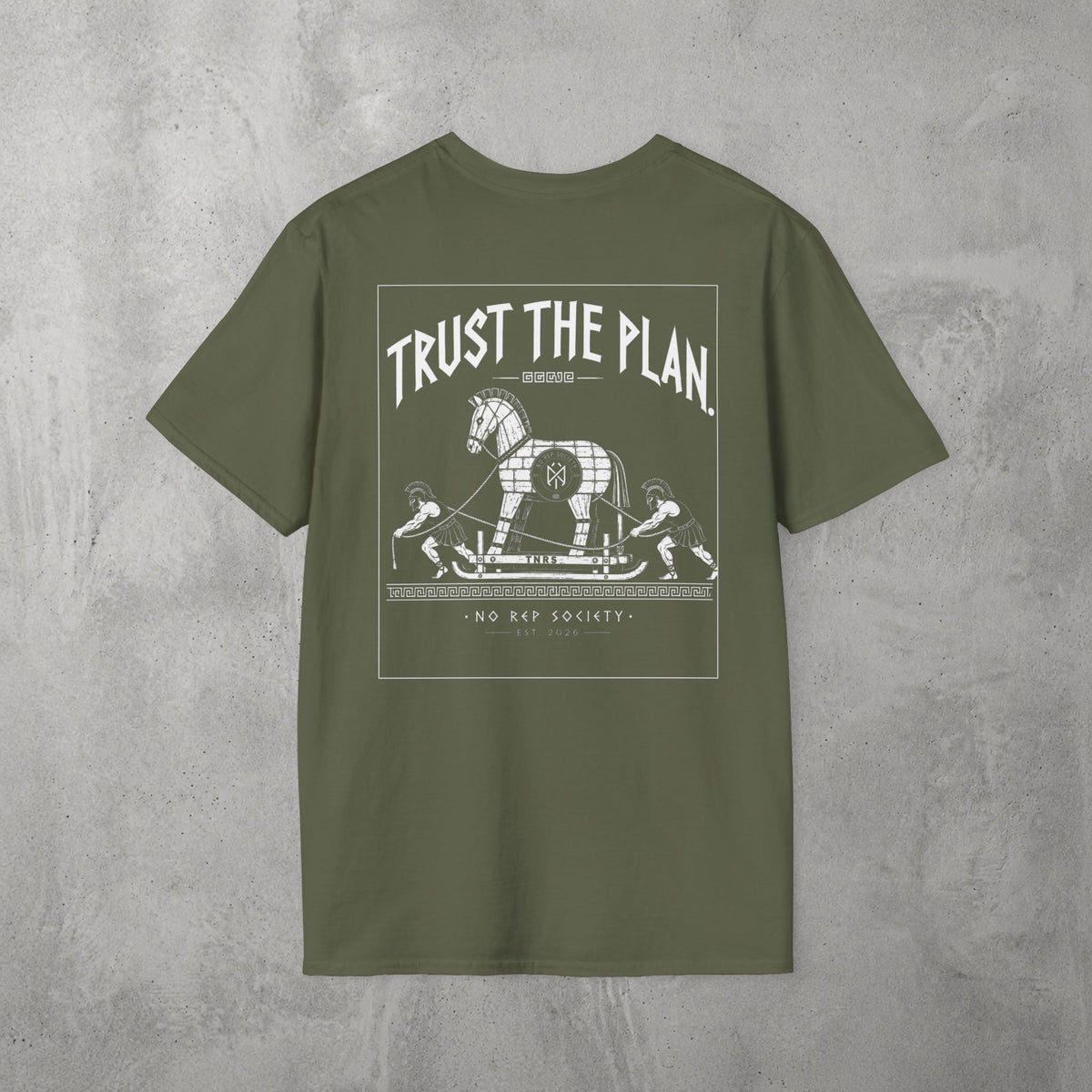 Military Green Trust The Plan Tee by The No Rep Society, flat lay on grey concrete, back print of the Trojan Horse with figures around it under TRUST THE PLAN lettering.