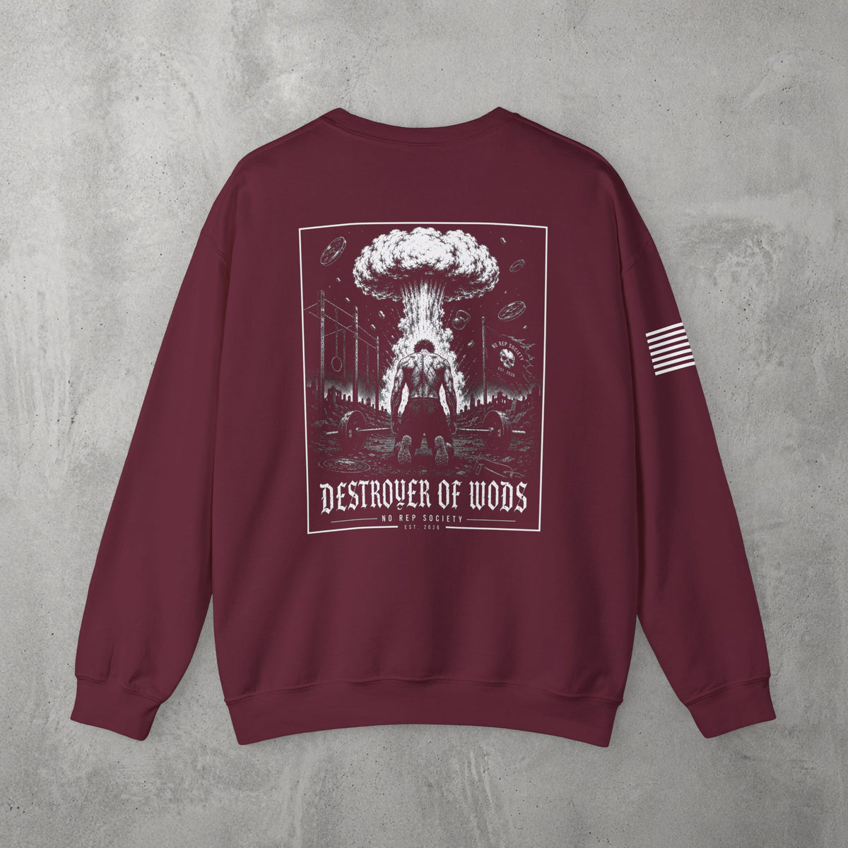 Maroon Destroyer of WODs (MEN) Crewneck by The No Rep Society, flat lay on grey concrete, back print of a mushroom cloud rising over a lone figure under a DESTROYER OF WODS banner.