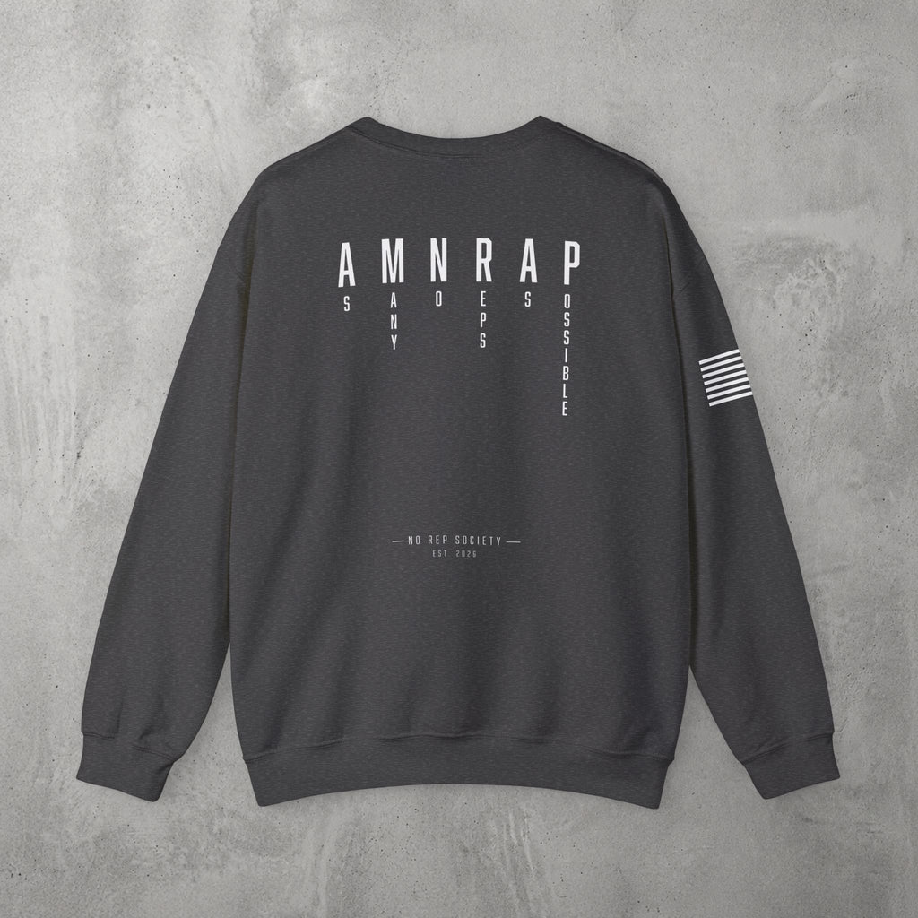 Dark Heather AMNRAP Crewneck by The No Rep Society, flat lay on grey concrete, back print of AMNRAP in wide spaced capitals with AS MANY NO-REPS AS POSSIBLE set vertically between the letters.