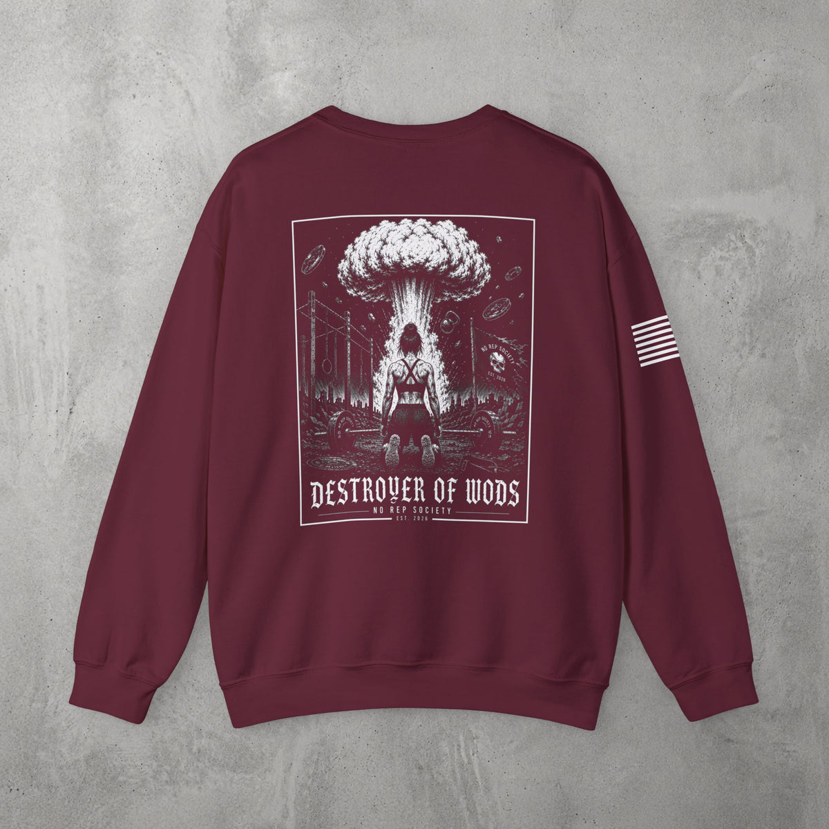 Maroon Destroyer of WODs (WOMEN) Crewneck by The No Rep Society, flat lay on grey concrete, back print of a mushroom cloud rising over a lone figure under a DESTROYER OF WODS banner.