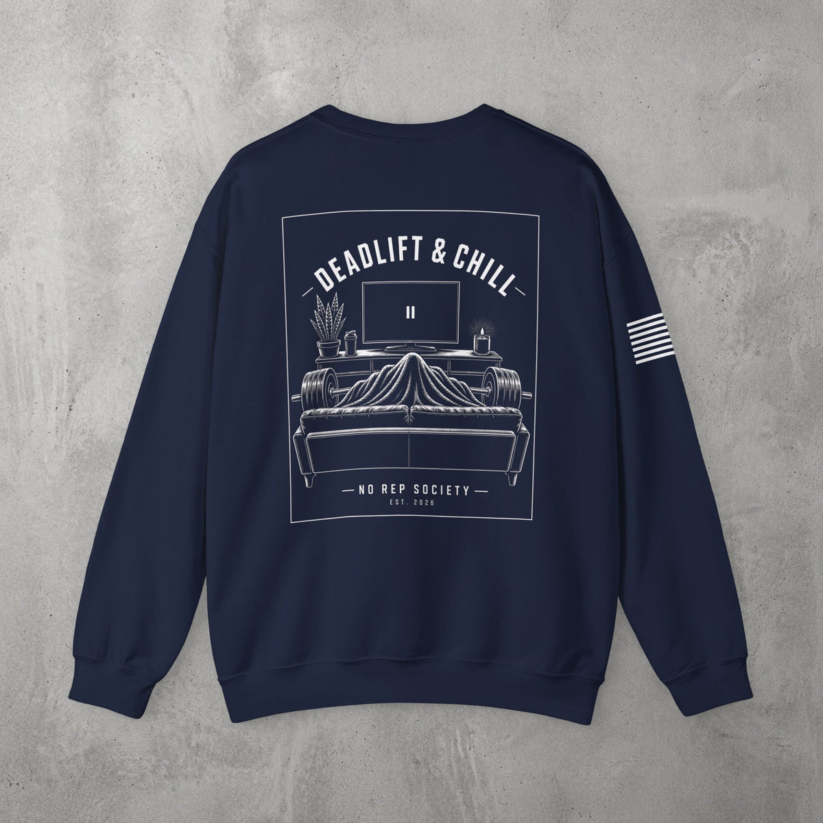 Navy Deadlift & Chill Crewneck by The No Rep Society, flat lay on grey concrete, back print of a bed and television drawn in fine line art under DEADLIFT & CHILL lettering.