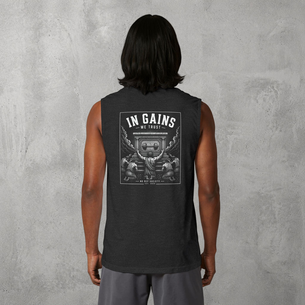 Dark Grey Heather In Gains We Trust Muscle Tank worn by a female model, back view showing the In Gains We Trust print.