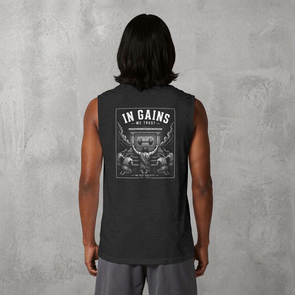 Dark Grey Heather In Gains We Trust Muscle Tank worn by a female model, back view showing the In Gains We Trust print.
