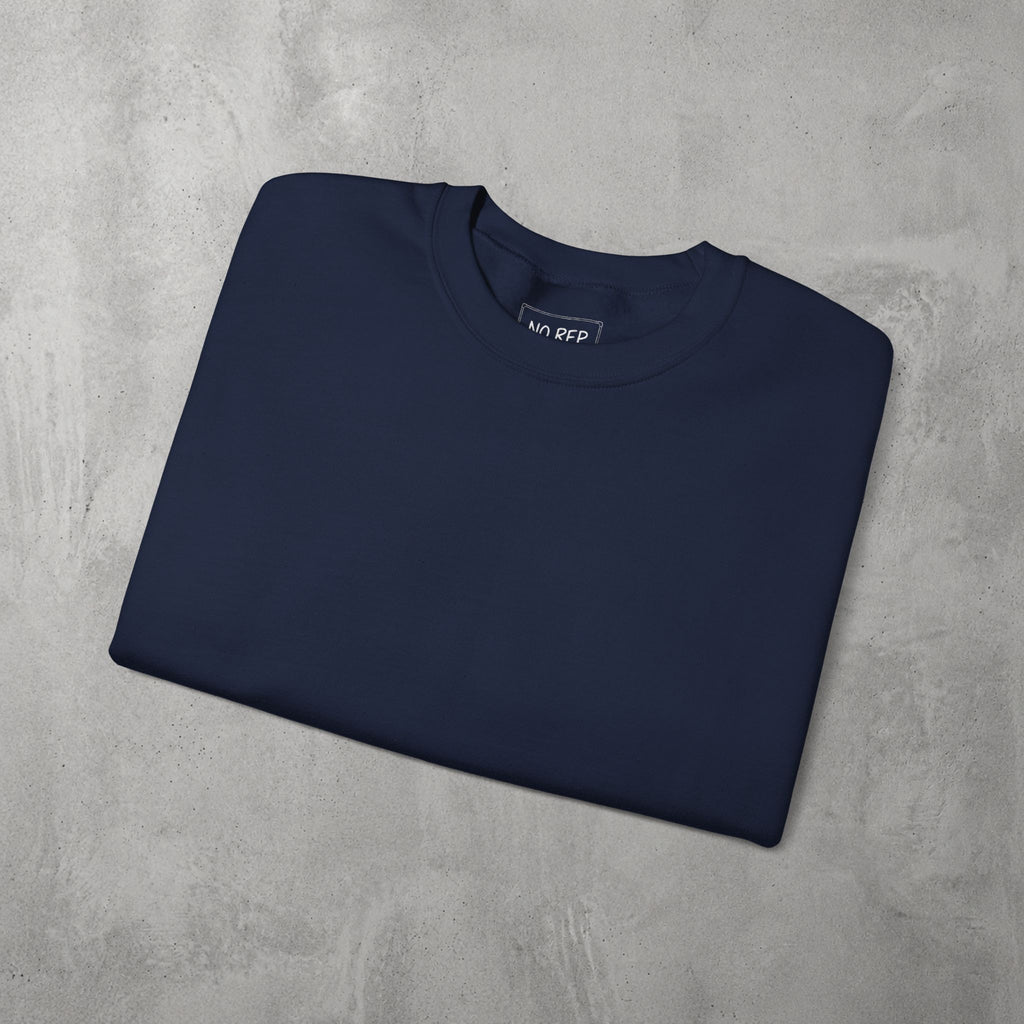 Navy AMNRAP Crewneck by The No Rep Society, folded flat on grey concrete.