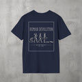 Navy Human Devolution (WOMEN) Tee by The No Rep Society, flat lay on grey concrete, back print of evolution silhouettes ending face-down on the floor under HUMAN DEVOLUTION lettering.