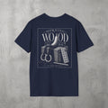 Navy Morning Wood Tee by The No Rep Society, flat lay on grey concrete, back print of a banana, gymnastic rings and a wooden plyo box under MORNING WOOD lettering.