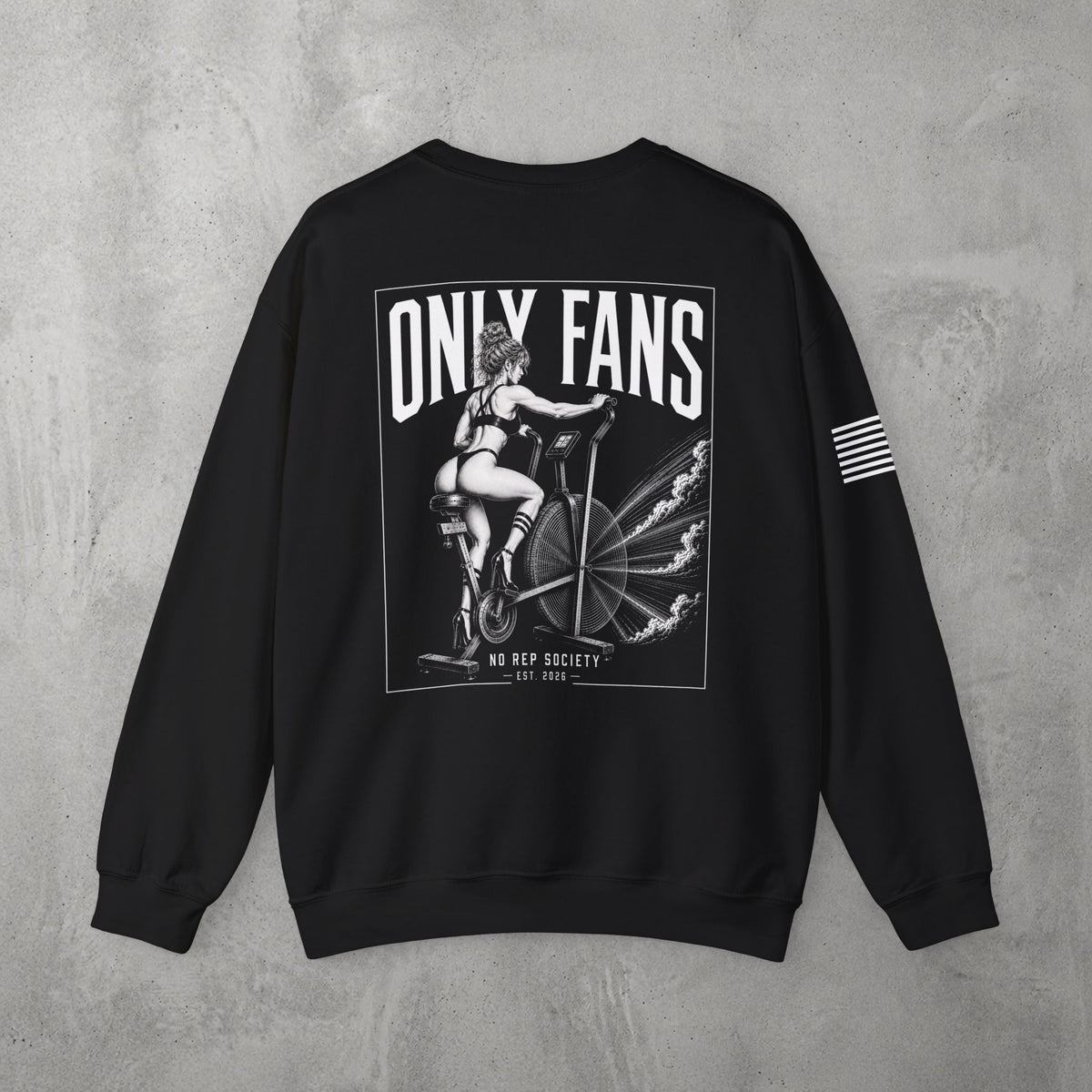 Black Only Fans Crewneck by The No Rep Society, flat lay on grey concrete, back print of a pin-up figure seated on a large industrial fan inside a bordered frame under ONLY FANS lettering, with striped sleeve detail.