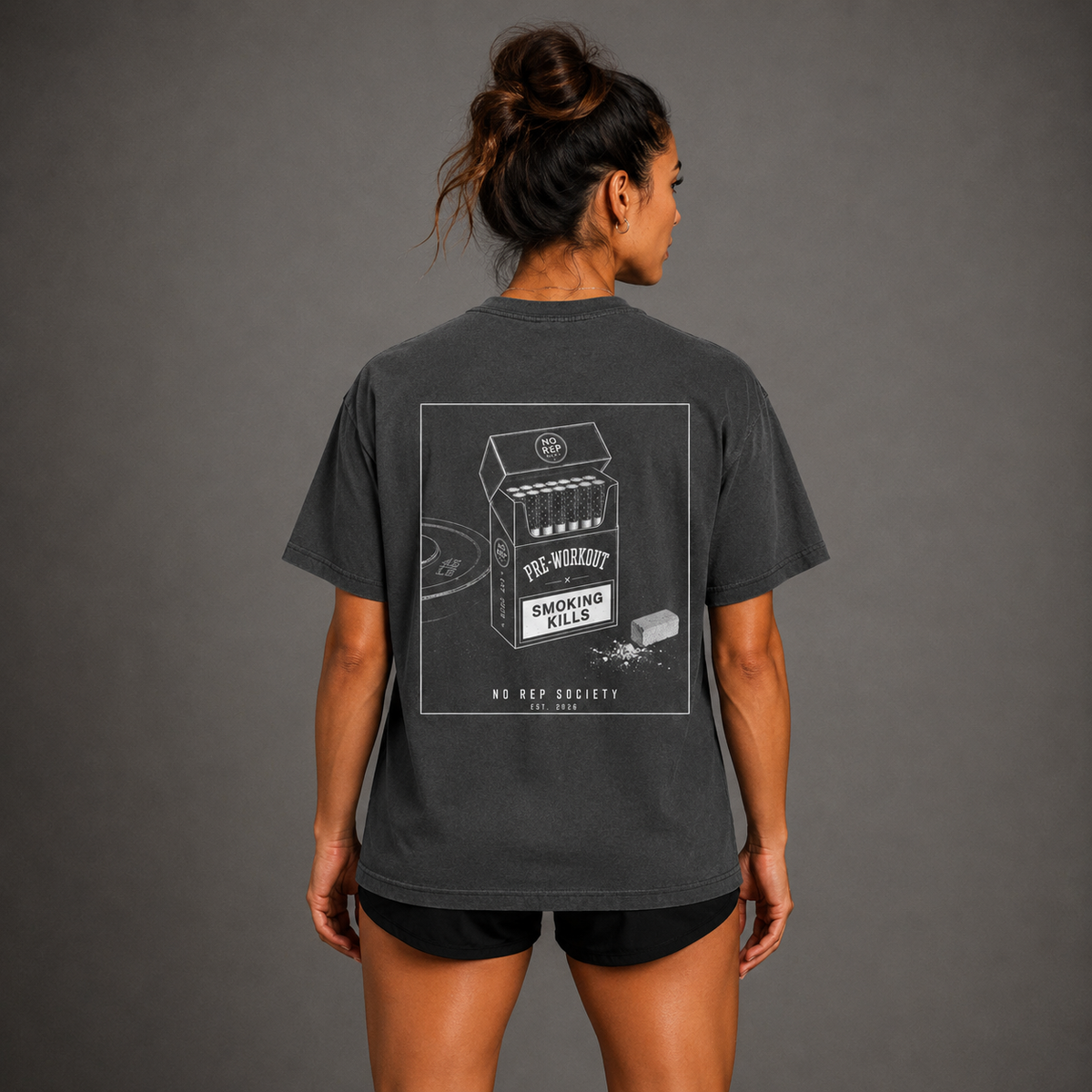Dark Heather Pre-Workout Tee by The No Rep Society, worn by a female model, back view showing the PRE-WORKOUT print.