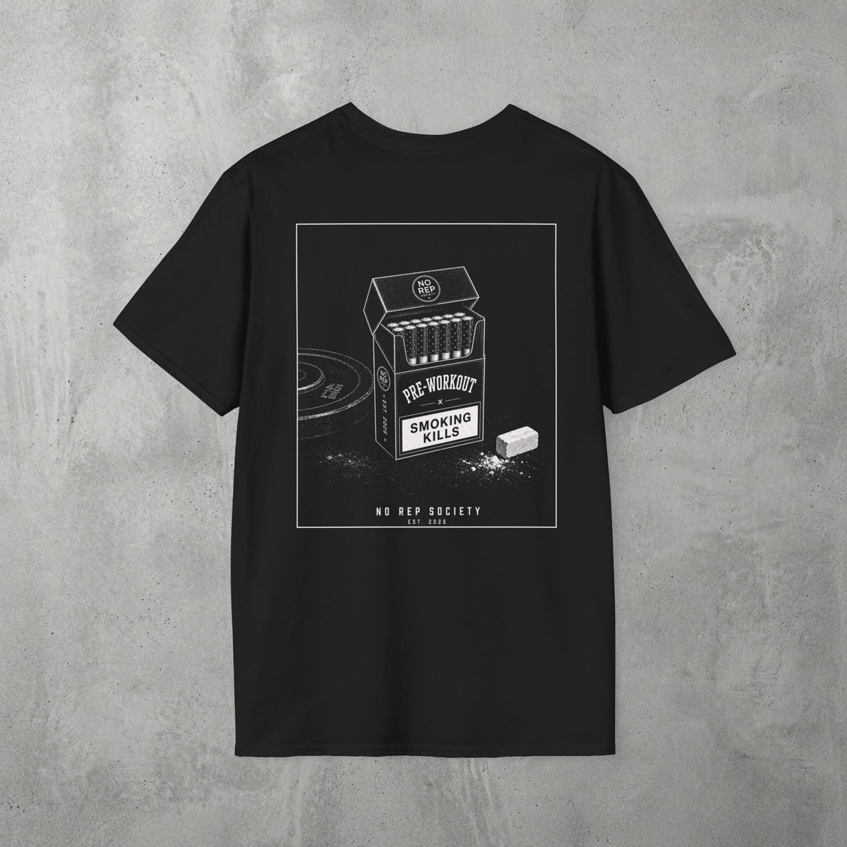 Black Pre-Workout Tee by The No Rep Society, flat lay on grey concrete, back print of an open cigarette pack labelled PRE-WORKOUT with a SMOKING KILLS warning and a scoop spilling powder.