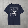 Navy I Know You're Watching Tee by The No Rep Society, flat lay on grey concrete, back print of a woman mid back-squat inside a bordered frame under I KNOW YOU'RE WATCHING lettering.