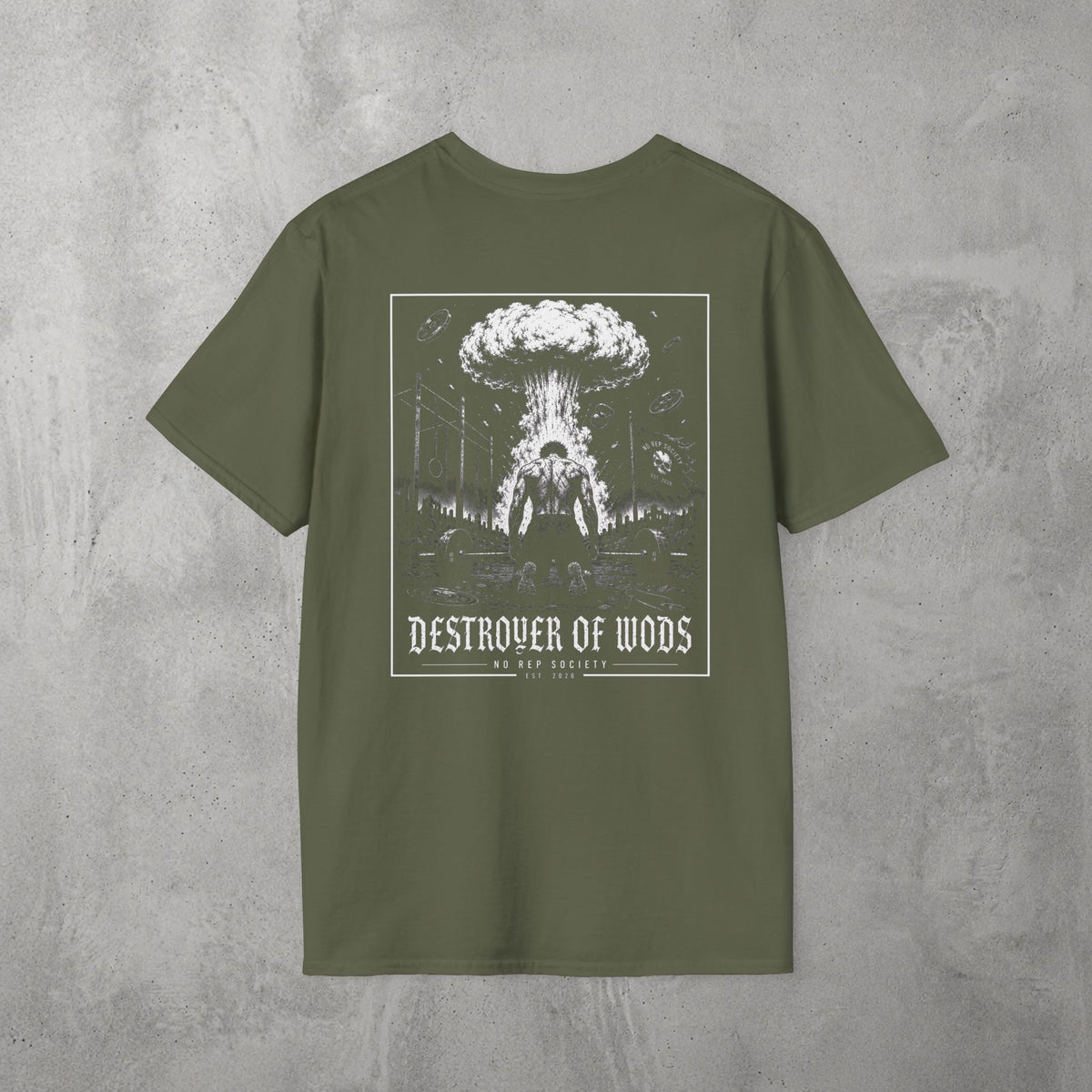 Military Green Destroyer of WODs (MEN) Tee by The No Rep Society, flat lay on grey concrete, back print of a mushroom cloud rising over a lone figure under a DESTROYER OF WODS banner.
