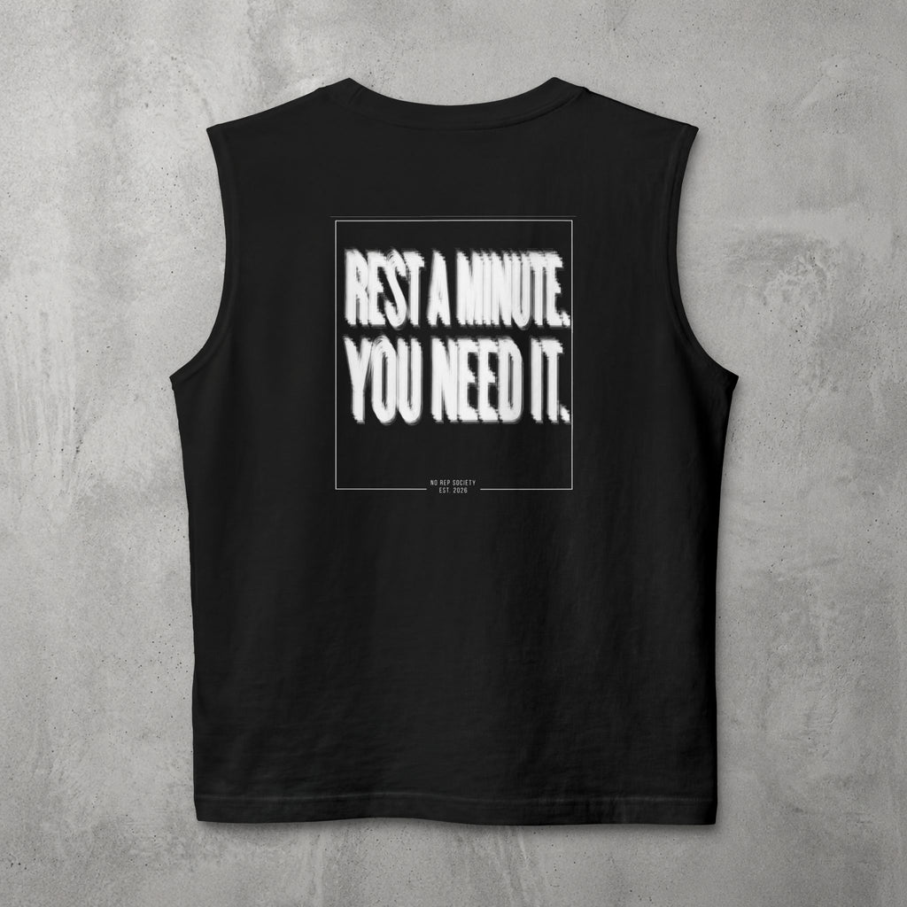 Black Rest A Minute Muscle Tank by The No Rep Society, flat lay on grey concrete, back print of REST A MINUTE. YOU NEED IT. in bold blurred capitals inside a thin frame.