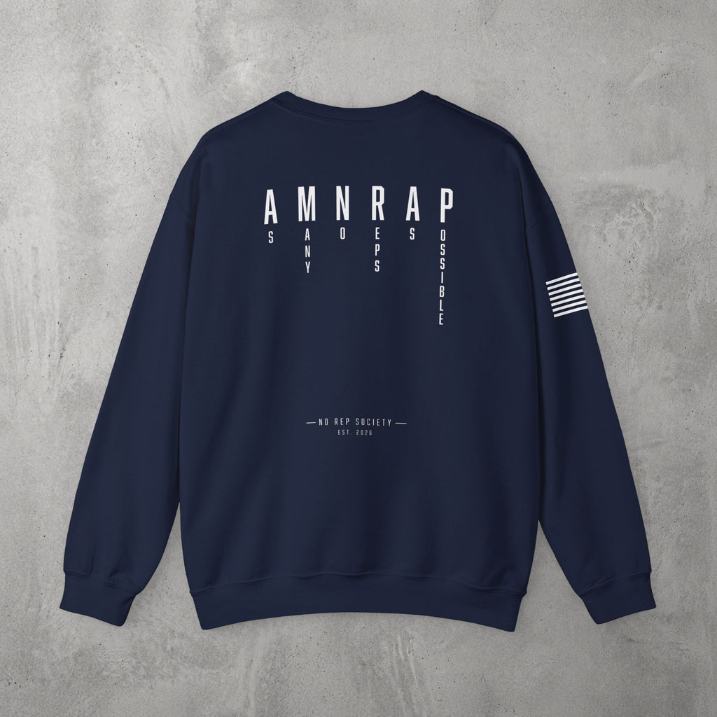 Navy AMNRAP Crewneck by The No Rep Society, flat lay on grey concrete, back print of AMNRAP in wide spaced capitals with AS MANY NO-REPS AS POSSIBLE set vertically between the letters.