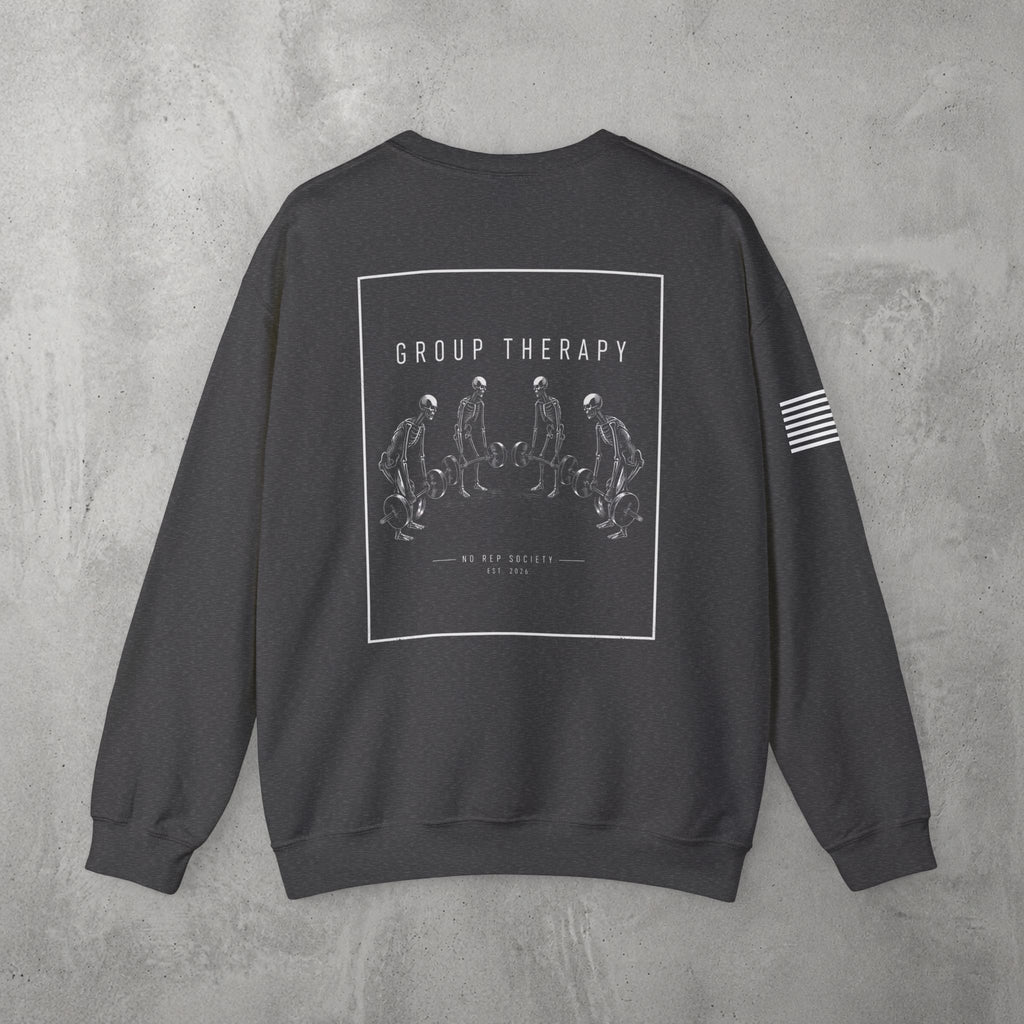 Dark Heather Group Therapy Crewneck by The No Rep Society, flat lay on grey concrete, back print of a circle of exhausted figures collapsed on the floor under GROUP THERAPY lettering.
