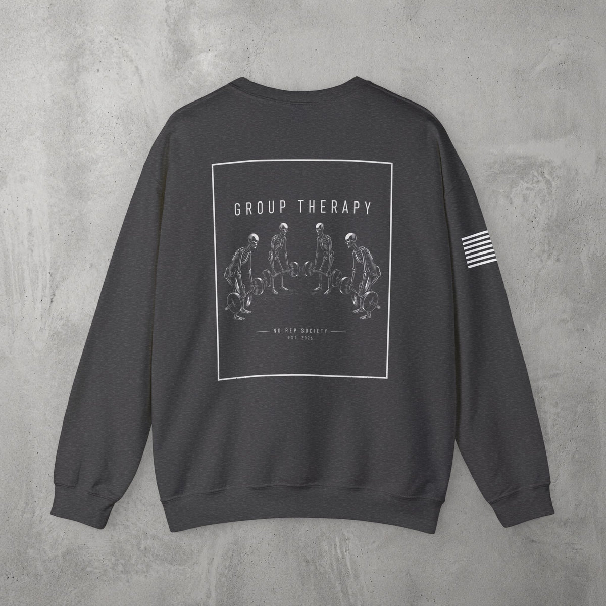 Dark Heather Group Therapy Crewneck by The No Rep Society, flat lay on grey concrete, back print of a circle of exhausted figures collapsed on the floor under GROUP THERAPY lettering.