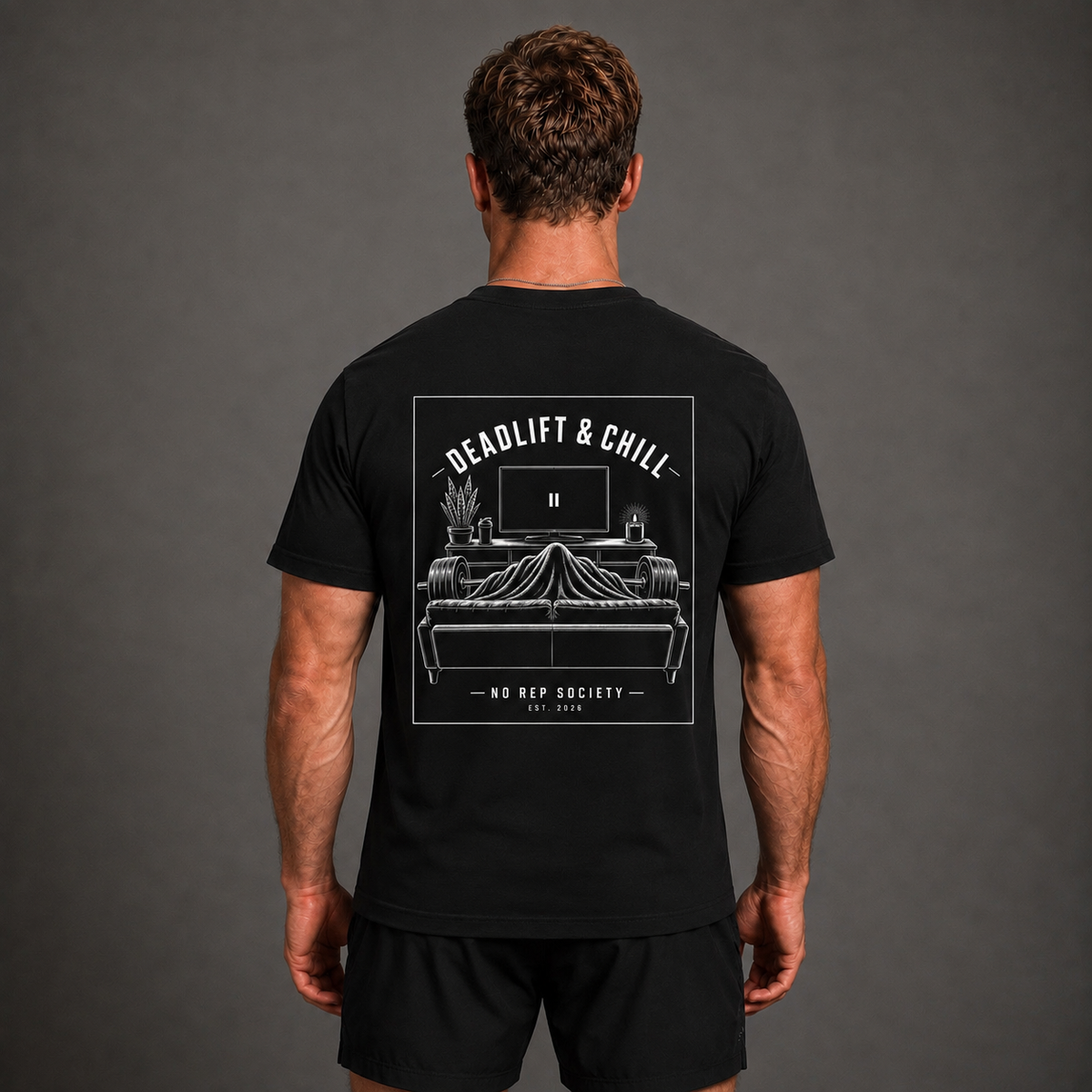 Black Deadlift & Chill Tee by The No Rep Society, worn by a male model, back view showing the DEADLIFT & CHILL print.