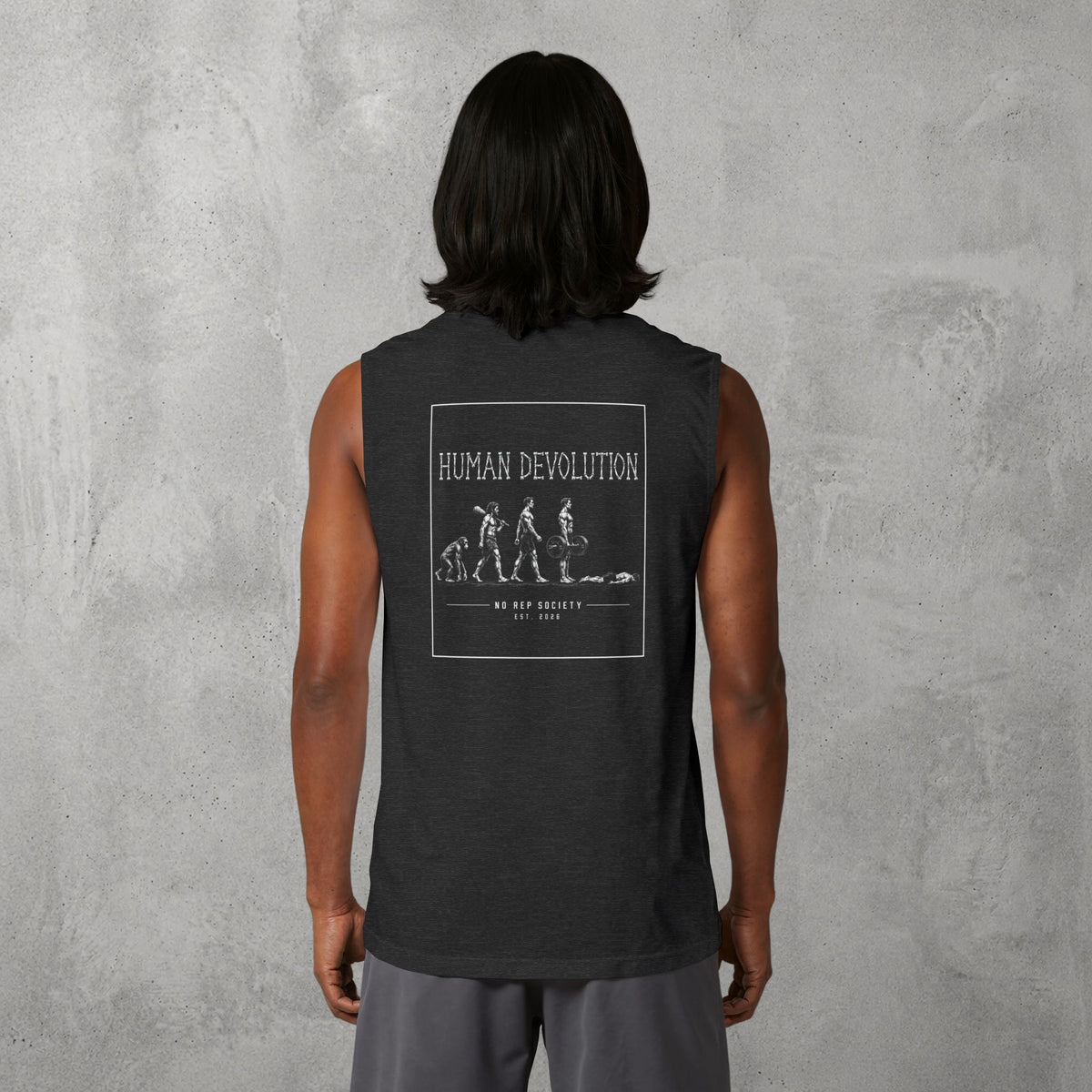 Dark Grey Heather Human Devolution (MEN) Muscle Tank worn by a female model, back view showing the Human Devolution print.