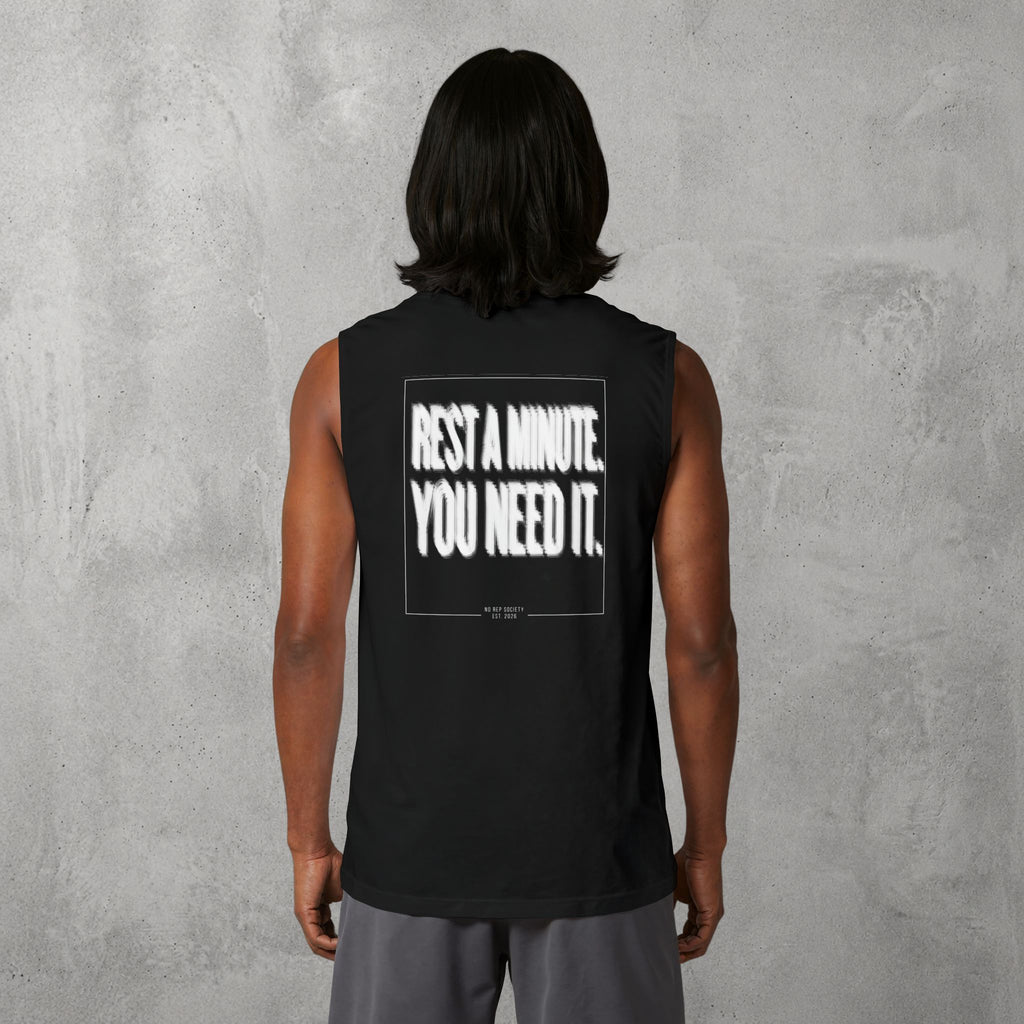 Black Rest A Minute Muscle Tank worn by a female model, back view showing the Rest A Minute print.
