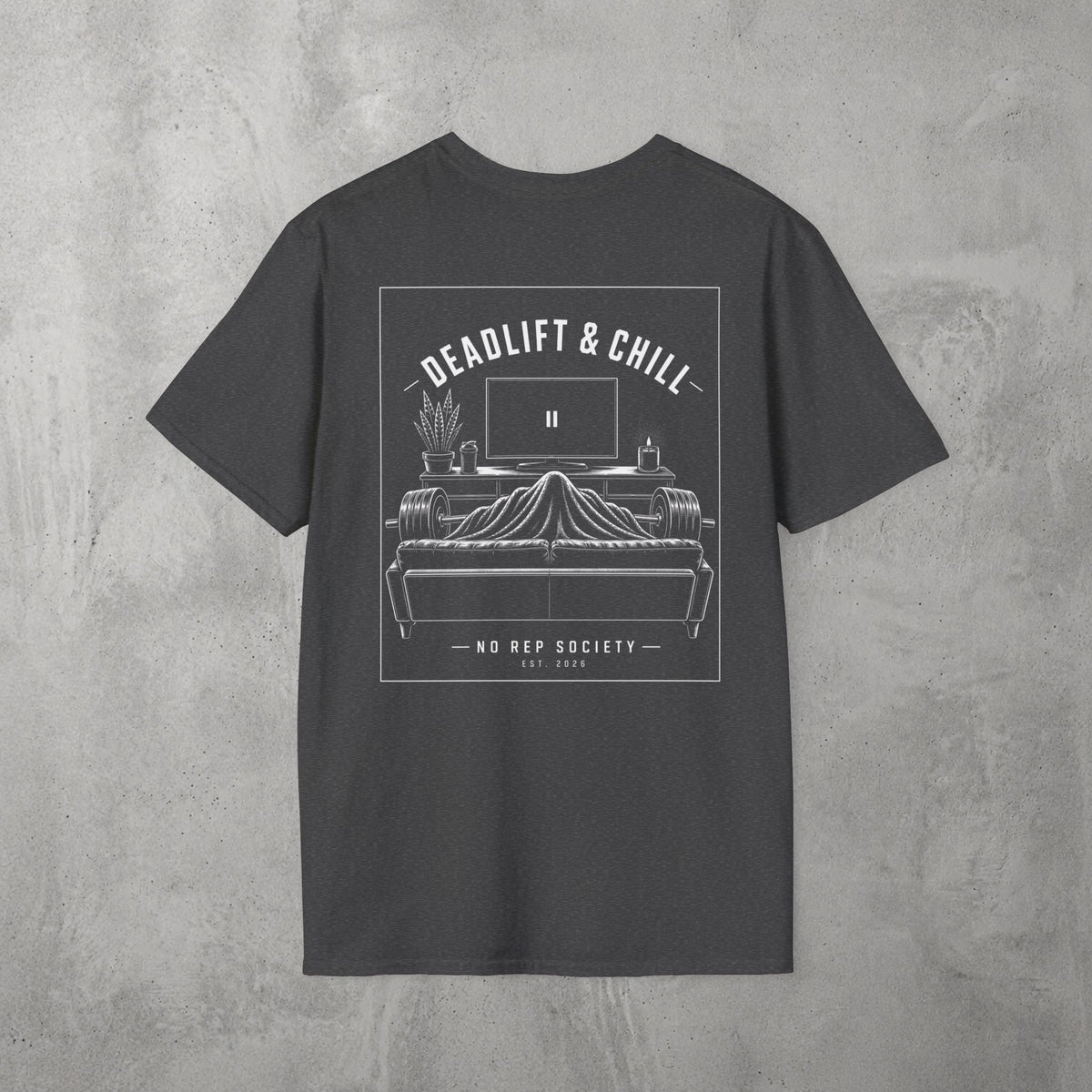 Dark Heather Deadlift & Chill Tee by The No Rep Society, flat lay on grey concrete, back print of a bed and television drawn in fine line art under DEADLIFT & CHILL lettering.