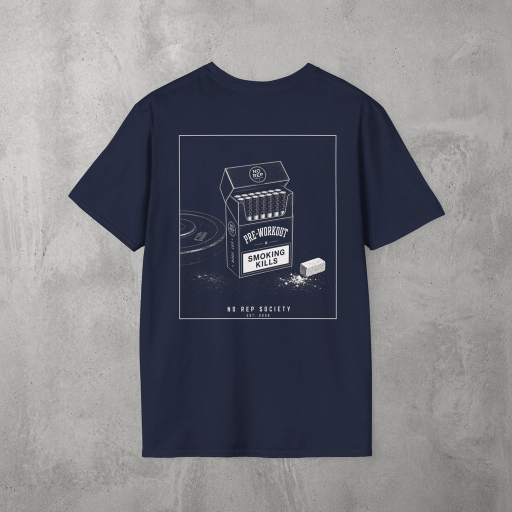 Navy Pre-Workout Tee by The No Rep Society, flat lay on grey concrete, back print of an open cigarette pack labelled PRE-WORKOUT with a SMOKING KILLS warning and a scoop spilling powder.