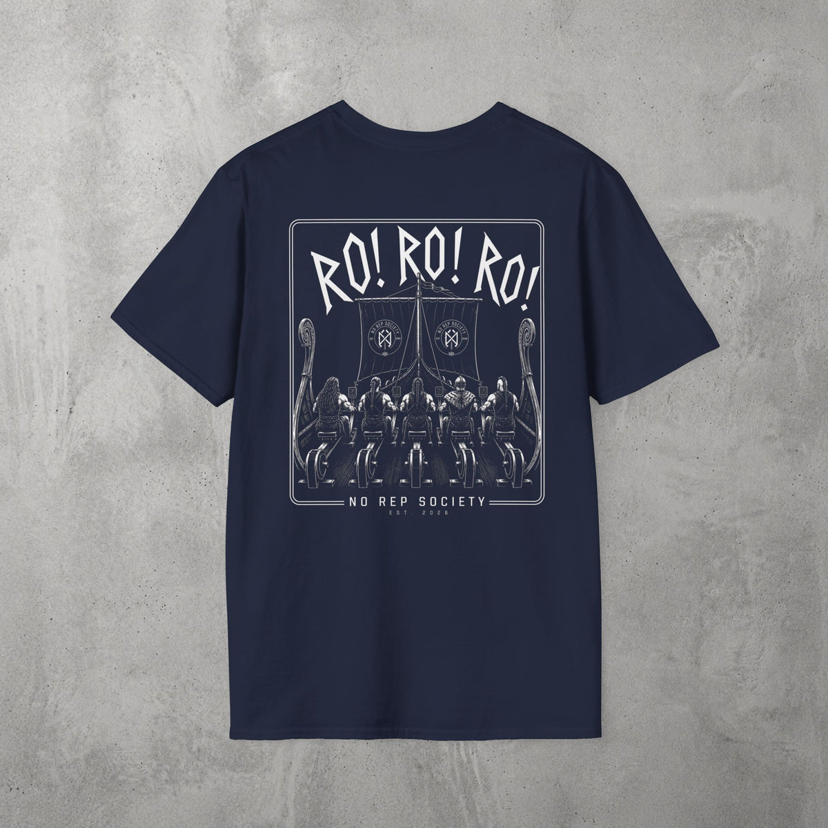 Navy RO! RO! RO! Viking Tee by The No Rep Society, flat lay on grey concrete, back print of a Viking longship with rows of oarsmen under sail beneath RO! RO! RO! lettering.
