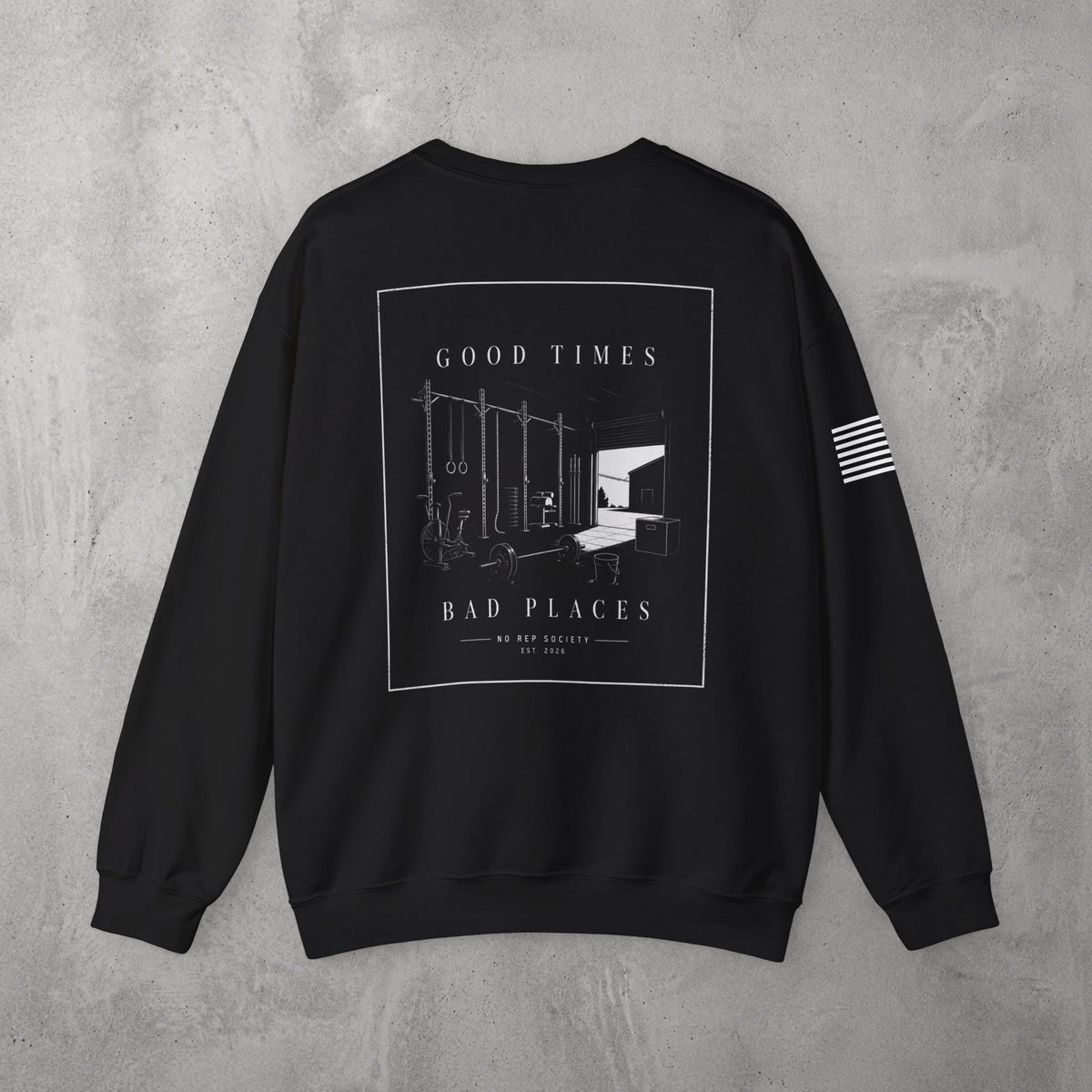 Black Good Times, Bad Places Crewneck by The No Rep Society, flat lay on grey concrete, back print of a rowing machine in fine line art between GOOD TIMES and BAD PLACES lettering.