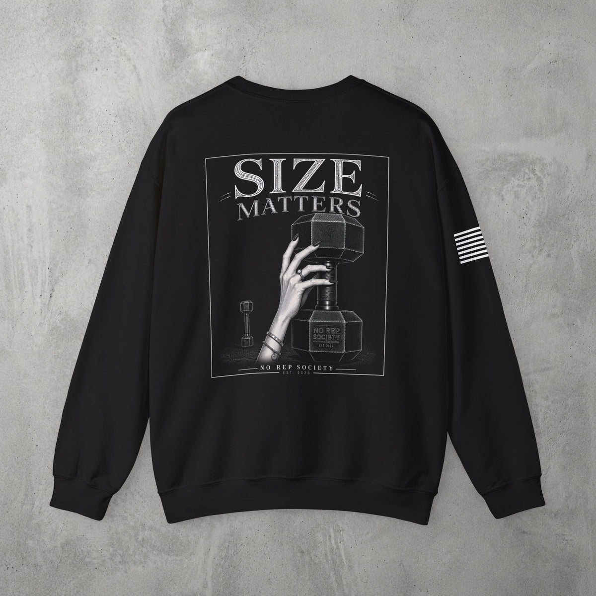 Black Size Matters Crewneck by The No Rep Society, flat lay on grey concrete, back print of a hand gripping a large weight plate under SIZE MATTERS lettering.