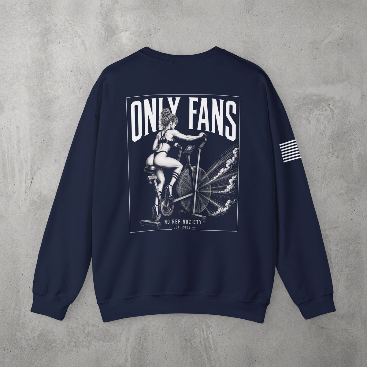 Navy Only Fans Crewneck by The No Rep Society, flat lay on grey concrete, back print of a pin-up figure seated on a large industrial fan inside a bordered frame under ONLY FANS lettering, with striped sleeve detail.
