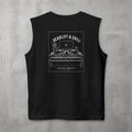 Black Deadlift & Chill Muscle Tank by The No Rep Society, flat lay on grey concrete, back print of a bed and television drawn in fine line art under DEADLIFT & CHILL lettering.