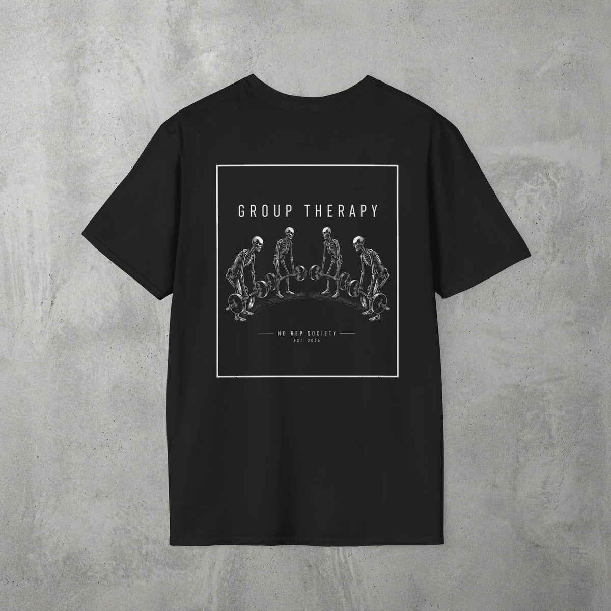 Black Group Therapy Tee by The No Rep Society, flat lay on grey concrete, back print of a circle of exhausted figures collapsed on the floor under GROUP THERAPY lettering.