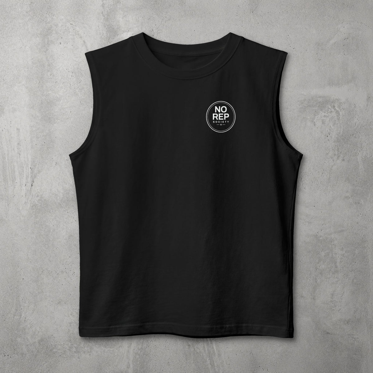 Black NRS Clean Muscle Tank by The No Rep Society, flat lay on grey concrete with a small circular NO REP SOCIETY chest logo and no back print.